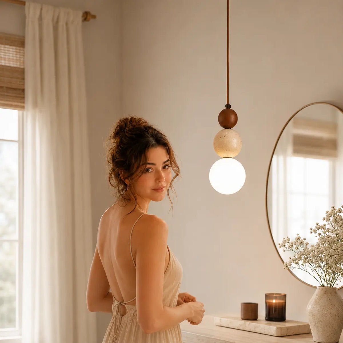 Veyra stone pendant light adding warm ambient light beside a bedroom mirror