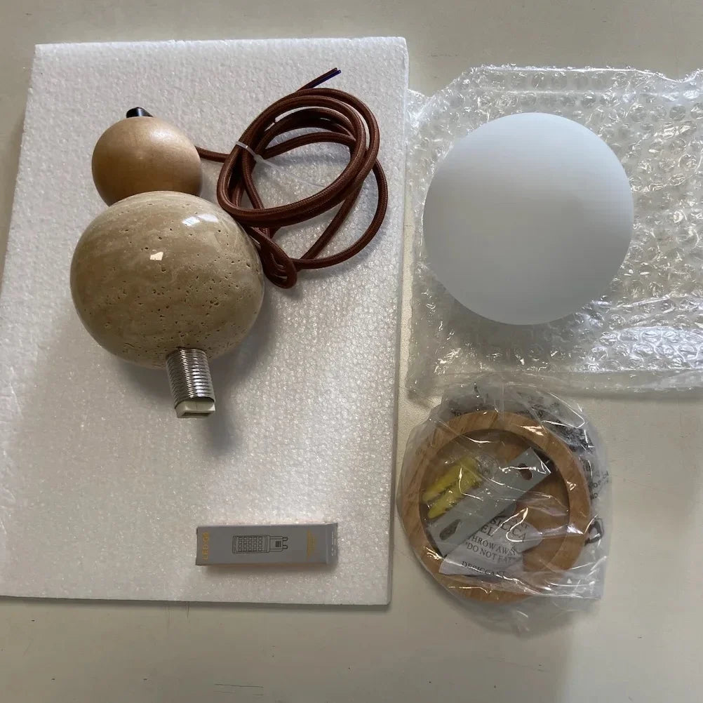 Veyra stone pendant light components with globe shade, cord, mounting canopy, and hardware