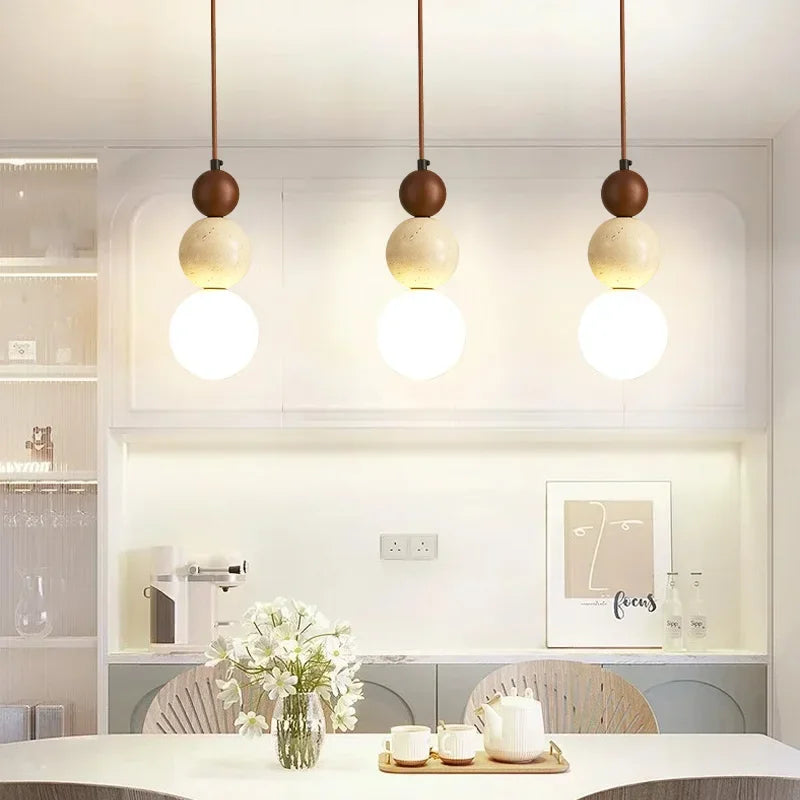 Veyra stone pendant lights adding soft warm illumination to a bright vanity room