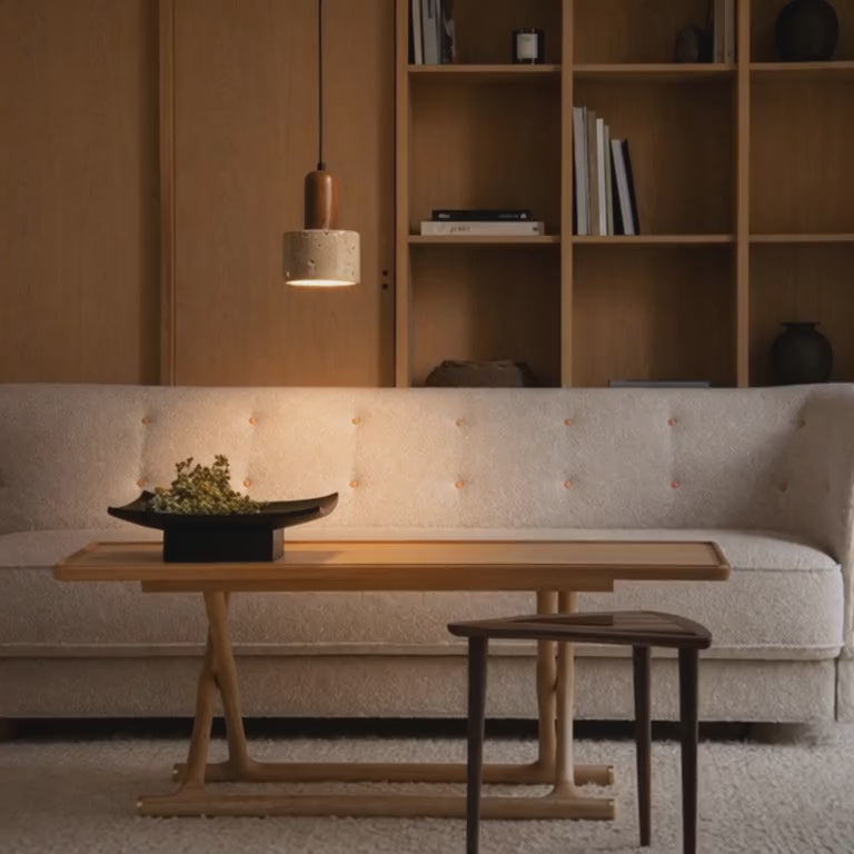 Video of the Eira stone pendant light creating warm ambient lighting above a dining table